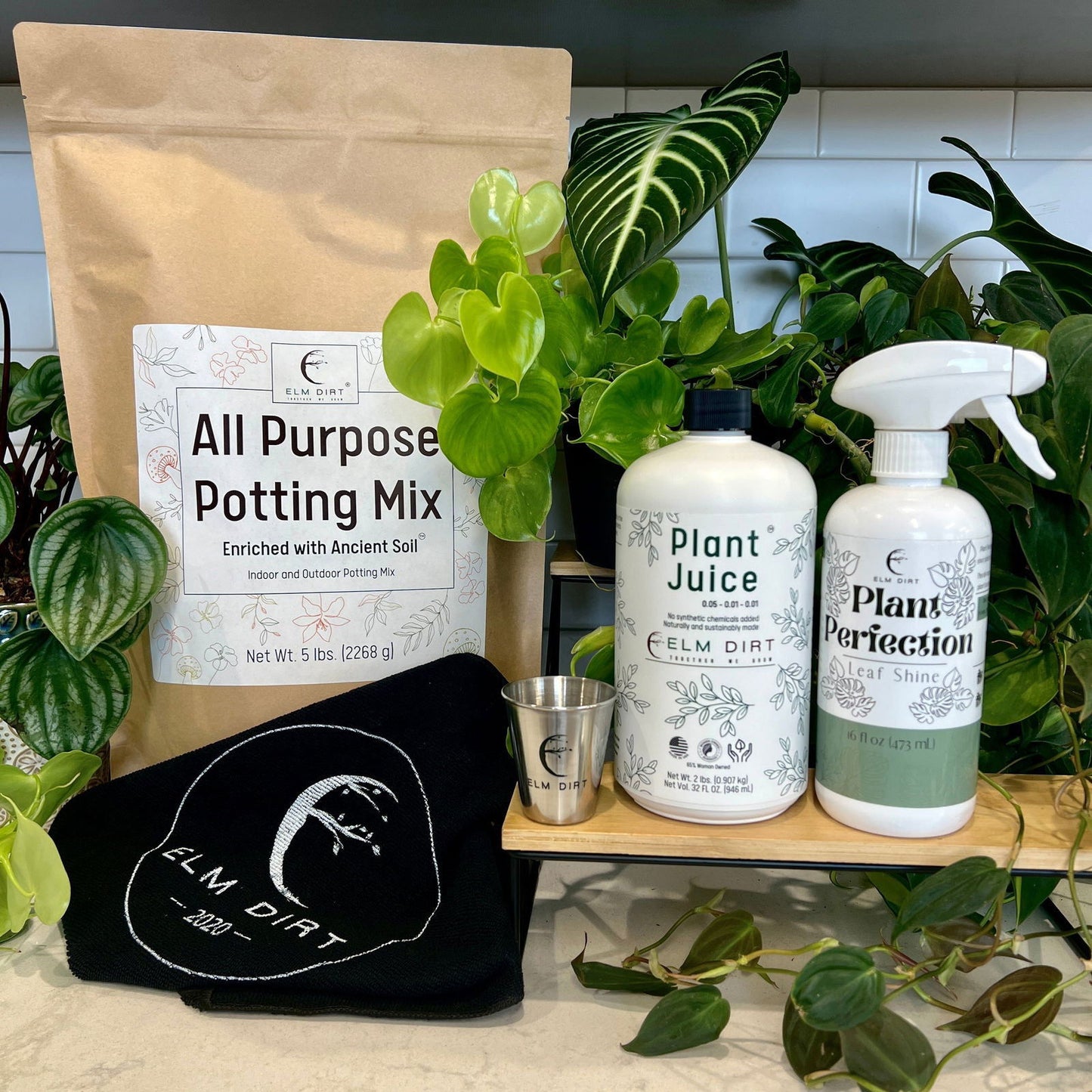 Elm Dirt Soil Starter Kit showing various soil bags and gardening tools for sustainable planting and soil health.