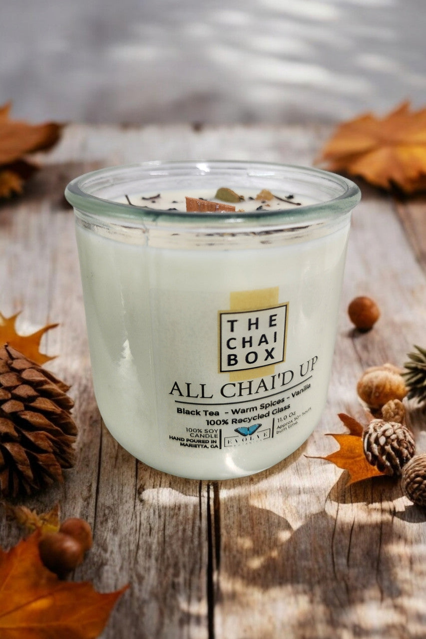 Evolve Botanica Rocks Candle Chai with wood wick and gemstone, soy wax, and warm earthy tones in a natural setting.