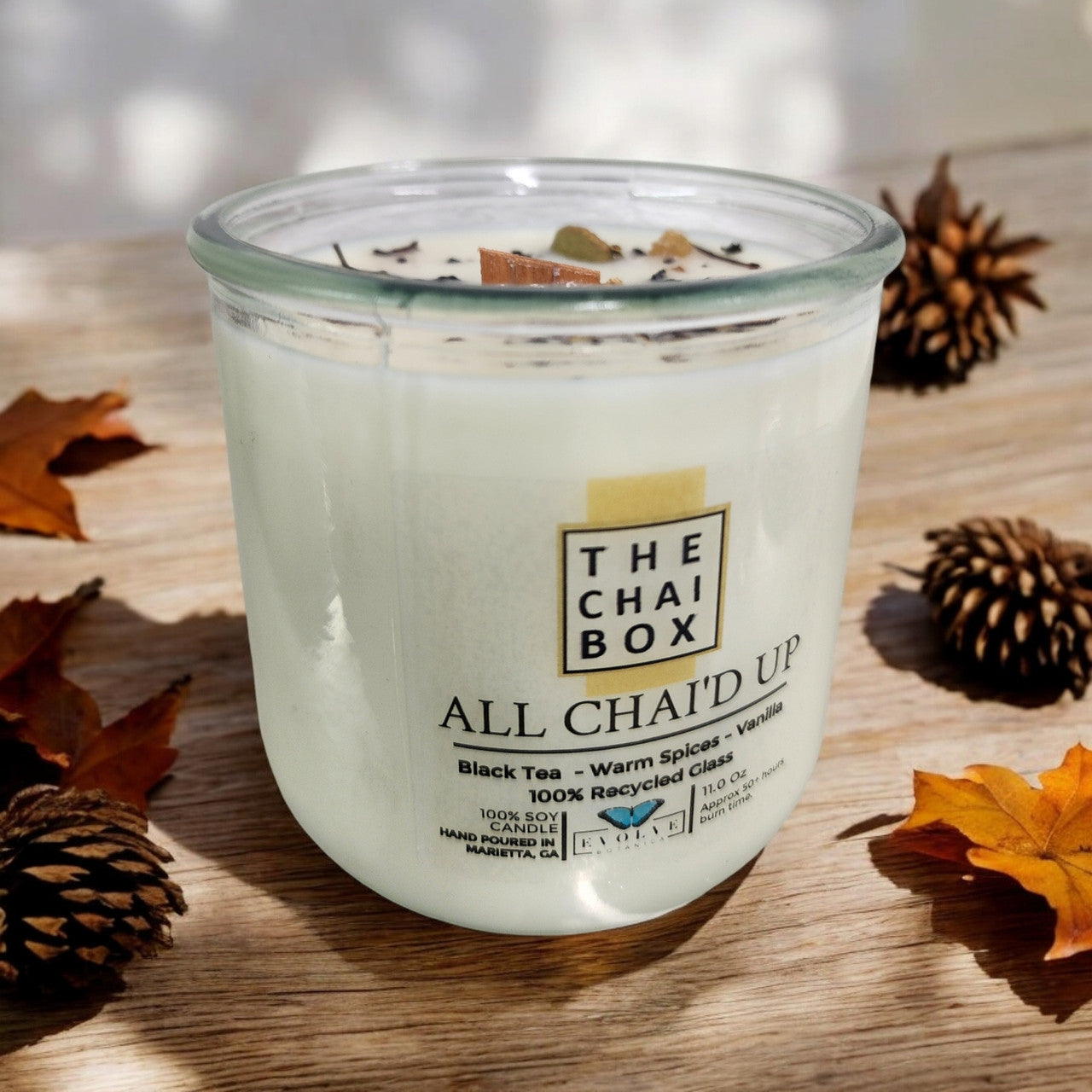 Evolve Botanica Rocks Candle Chai with wood wick and gemstone, soy candle in a glass jar for soothing aromatic ambiance.