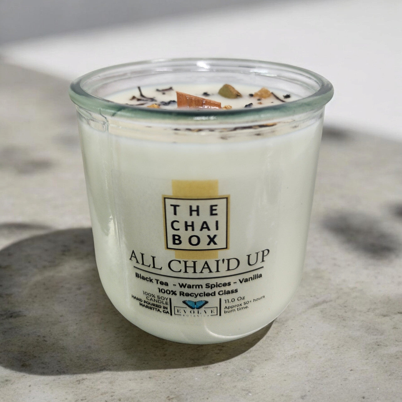 Evolve Botanica Rocks Candle Chai with wood wick and gemstone, soy wax, and calming earthy tones.