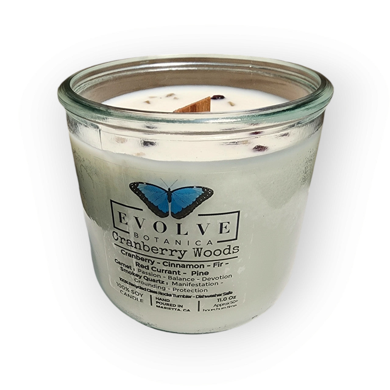 Evolve Botanica Cranberry Woods soy candle with wood wick, garnet and smoky quartz gemstones, in a glass jar.