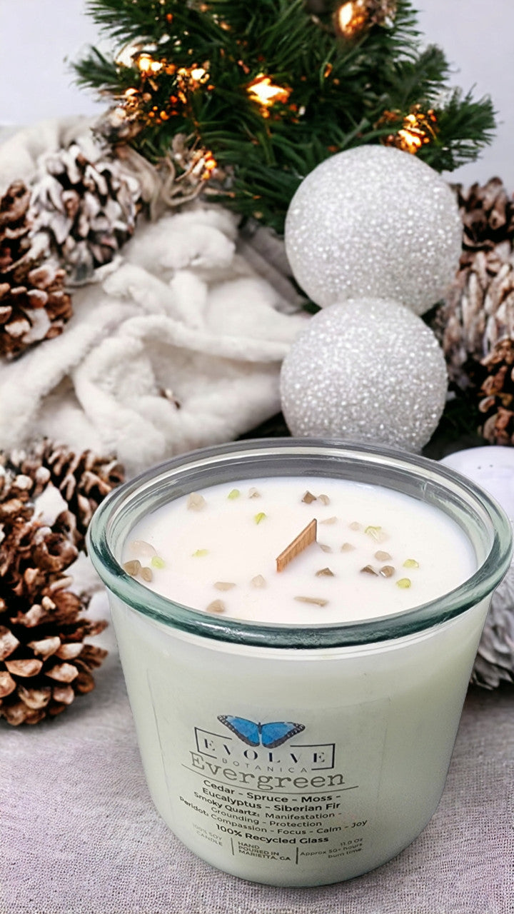 Evergreen Rocks Candle by Evolve Botanica with wood wick, Peridot and Smoky Quartz gemstones, soy wax, and natural decor.