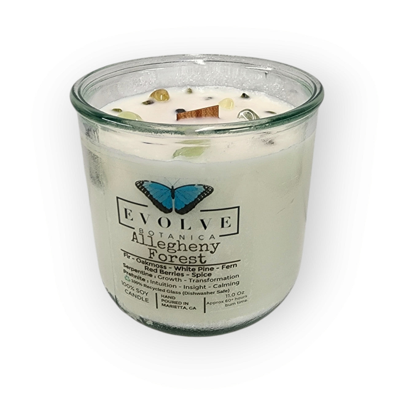Rocks Candle Falling Leaves by Evolve Botanica featuring a soy candle with wood wick, Peridot, Red Jasper, and Yellow Aventurine gemstones.