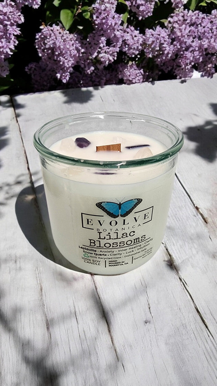 Evolve Botanica Rocks Candle with Lilac Blossoms, wood wick, Lepidolite gemstone, soy wax, and botanical design.