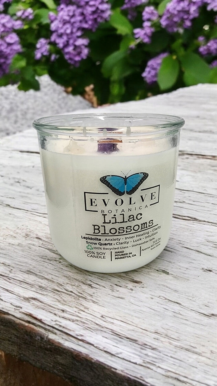 Evolve Botanica Rocks Candle Lilac Blossoms with wood wick and lepidolite gemstone, scented soy candle in a glass jar.