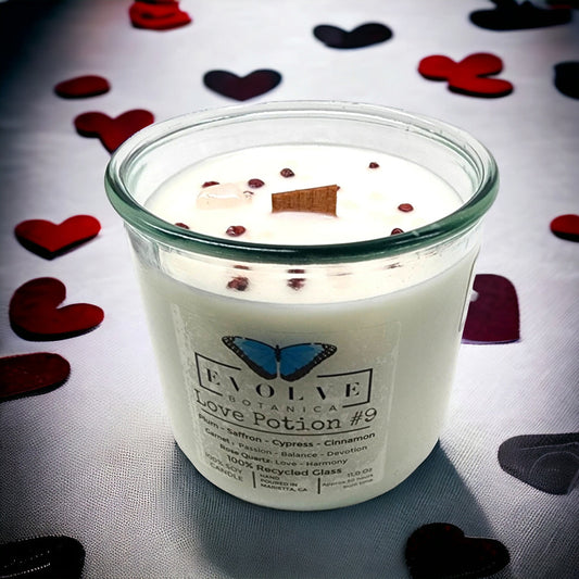 Evolve Botanica Rocks Candle Love Potion #9 with garnet and rose quartz gemstones, soy wax, and wood wick for a cozy ambiance.