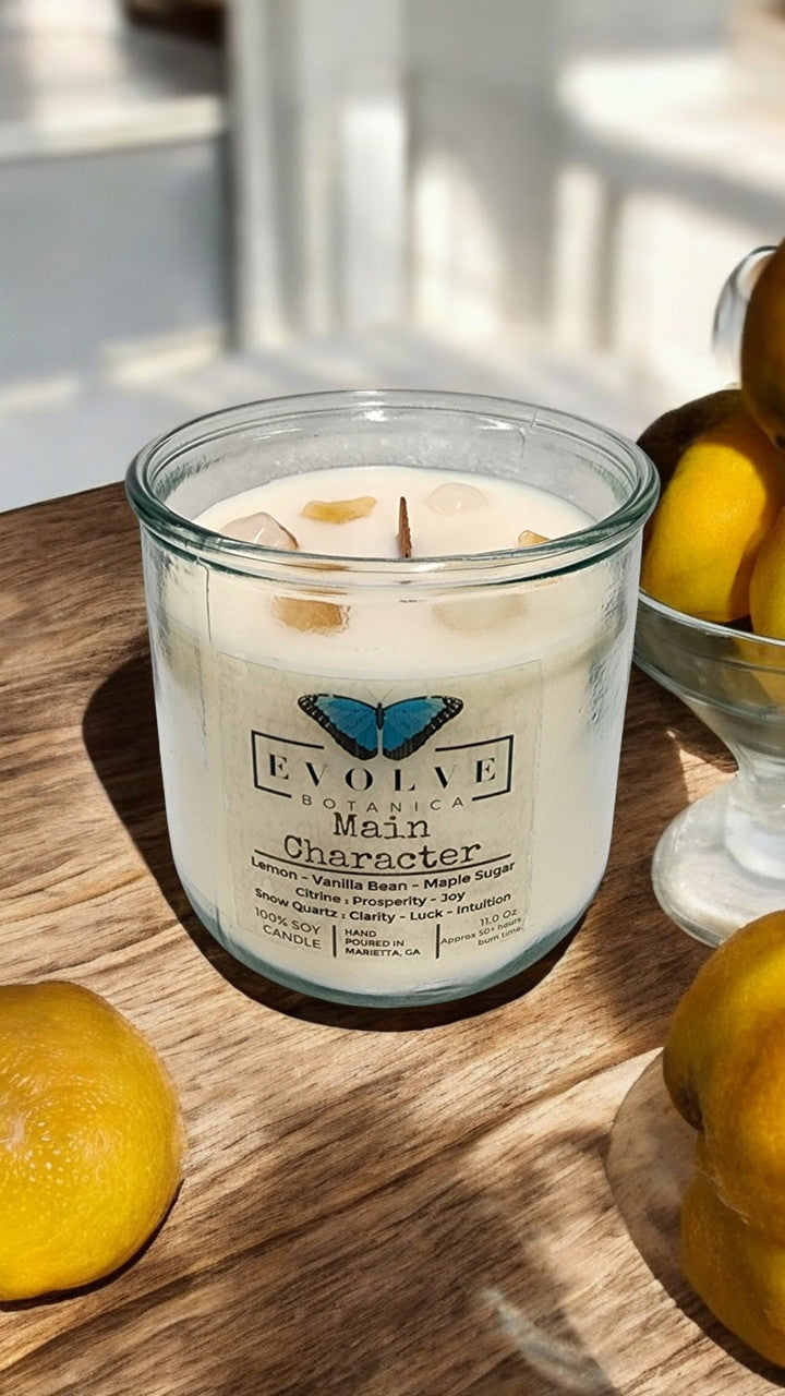 Evolve Botanica Rocks Candle Main Character with wood wick, citrine, and snow quartz gemstones in a soy candle.