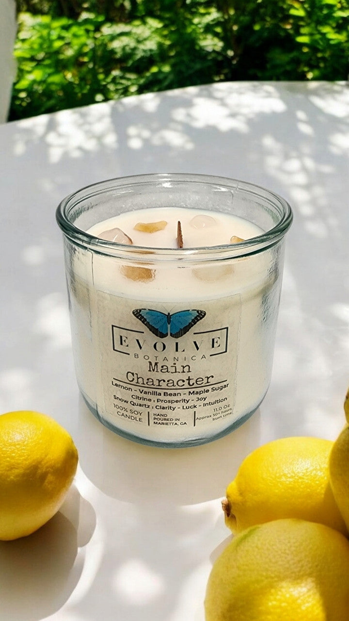Evolve Botanica Rocks Candle Main Character with wood wick, citrine, and snow quartz gemstones in a soy candle container.