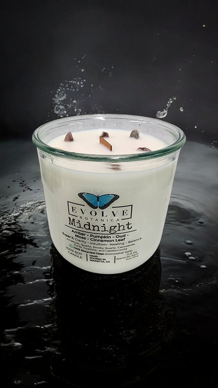 Evolve Botanica Midnight Rocks Candle with wood wick and Super Seven gemstone, a soy candle featuring vibrant gemstones and a calming glow.
