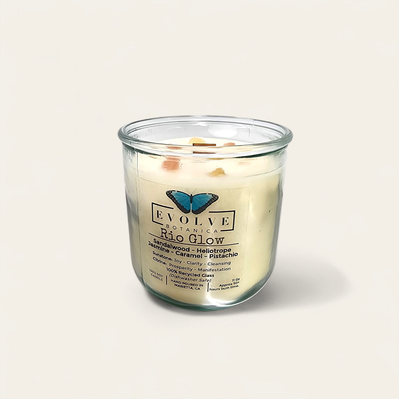 Evolve Botanica Rocks Candle Rio Glow soy candle with Sunstone and Citrine gemstones, featuring a wood wick and natural aesthetic.