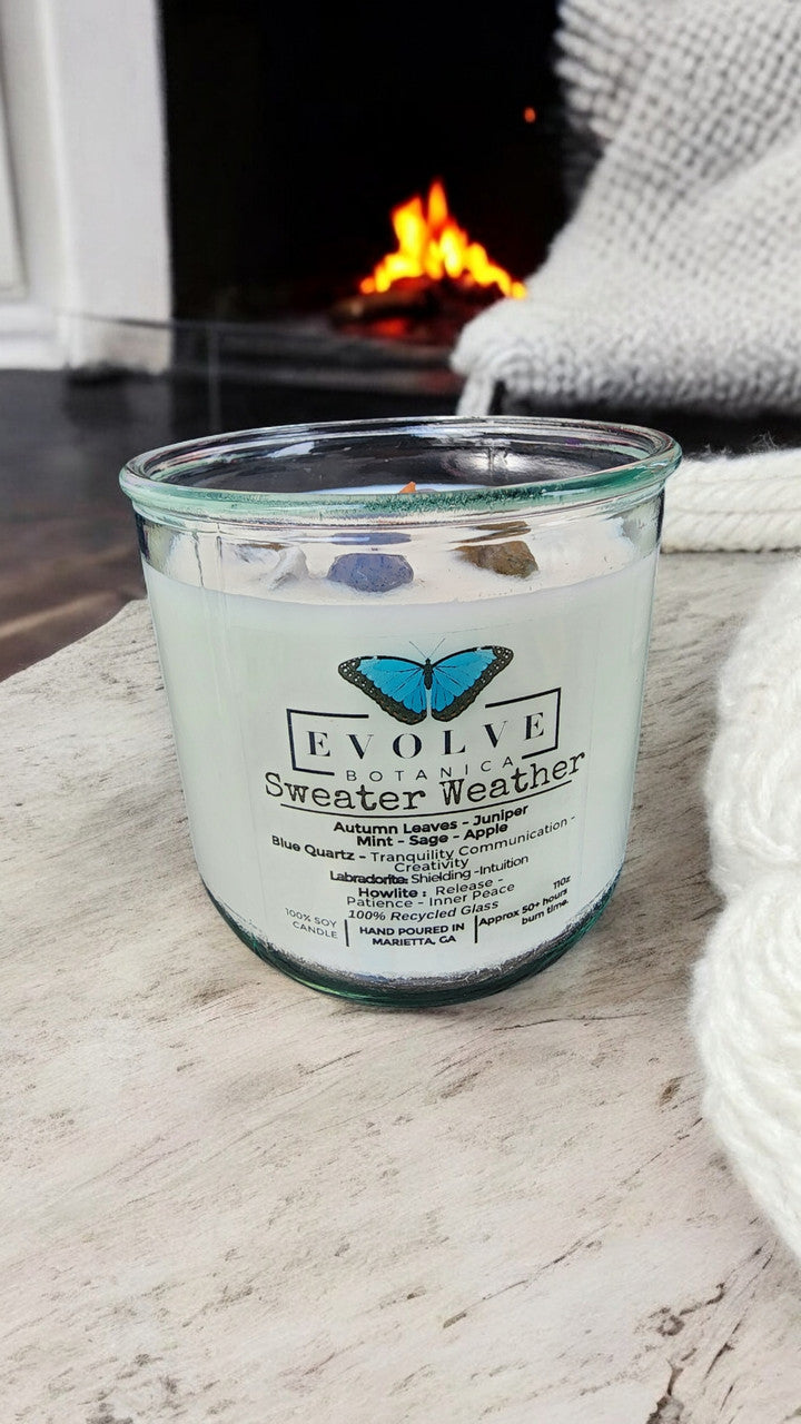 Evolve Botanica Rocks Candle Sweater Weather with wood wick, Howlite, Labradorite, Sodalite, and soy wax, displaying candles and gemstones.