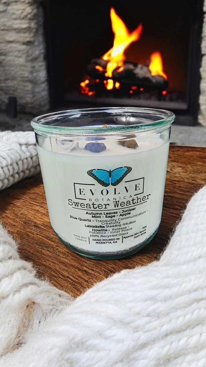 Evolve Botanica Rocks Candle Sweater Weather with wood wick, Howlite, Labradorite, and Sodalite, set in a soy candle container.