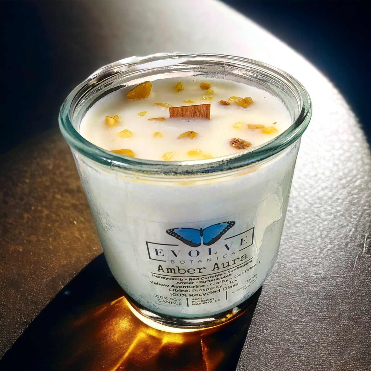 Evolve Botanica Rocks Candle Warm Wishes with wood wick, Citrine and Aventurine gemstones, in a soy wax candle for a cozy ambiance.