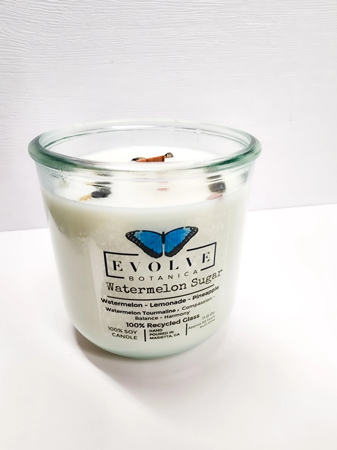 Evolve Botanica Watermelon Sugar Rocks Candle with wood wick and gemstone accents in a soy candle jar.