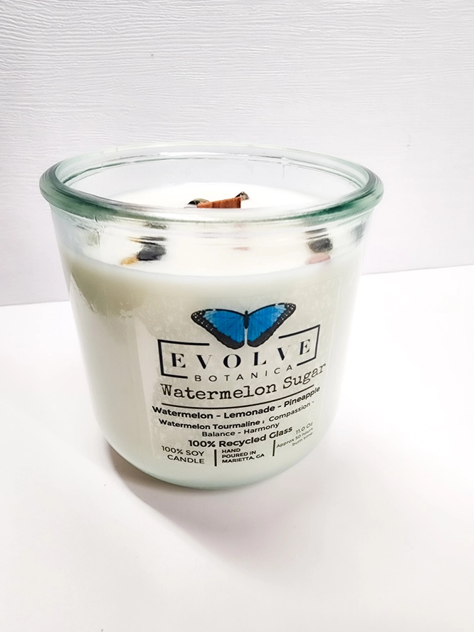 Evolve Botanica Watermelon Sugar Rocks Candle with wood wick and gemstone embedded in soy wax for a decorative, fragrant candle.