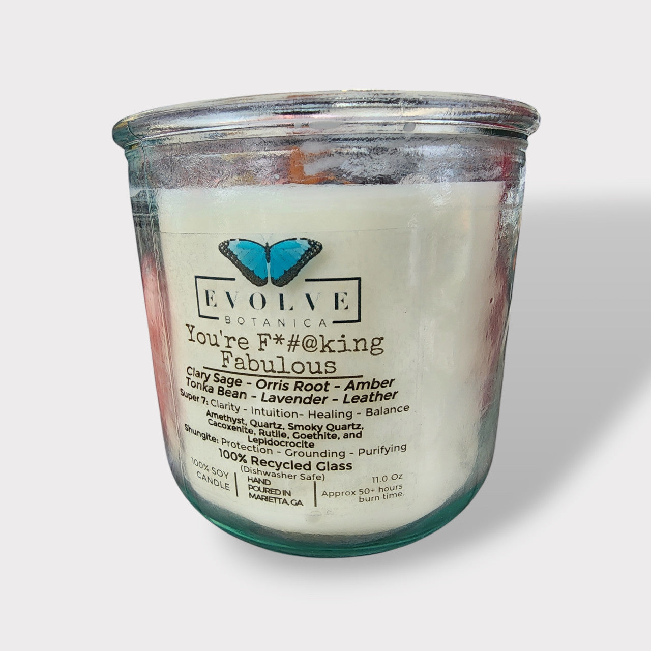 Amethyst, quartz, smoky quartz, cacoxenite, rutile, goethite, and lepidocrocite Rocks Candle by Evolve Botanica with colorful mineral stones.
