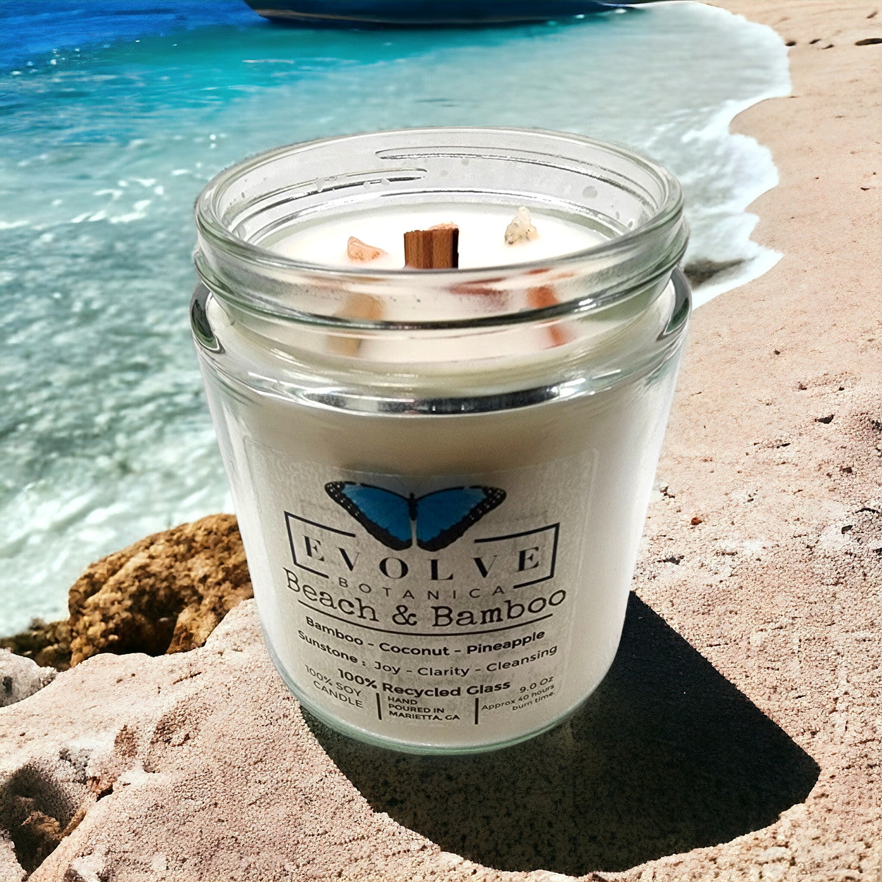 Evolve Botanica Classic 9oz Jam Jar Crystal Soy Candle with Beach & Bamboo scent, natural wood wick and Sunstone accents.