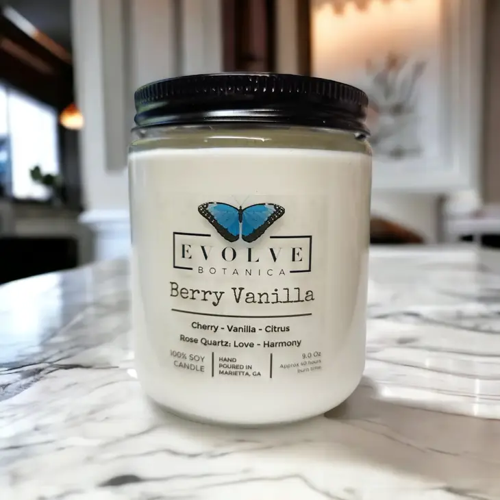 Evolve Botanica Classic 9oz jam jar soy candle with berry vanilla scent, featuring a rose quartz crystal and natural wood wick.