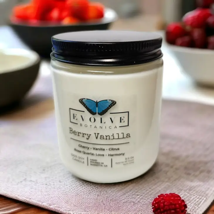 Evolve Botanica Classic 9oz Jam Jar Crystal Soy Candle with Berry Vanilla scent, natural wood wick, and rose quartz decoration.