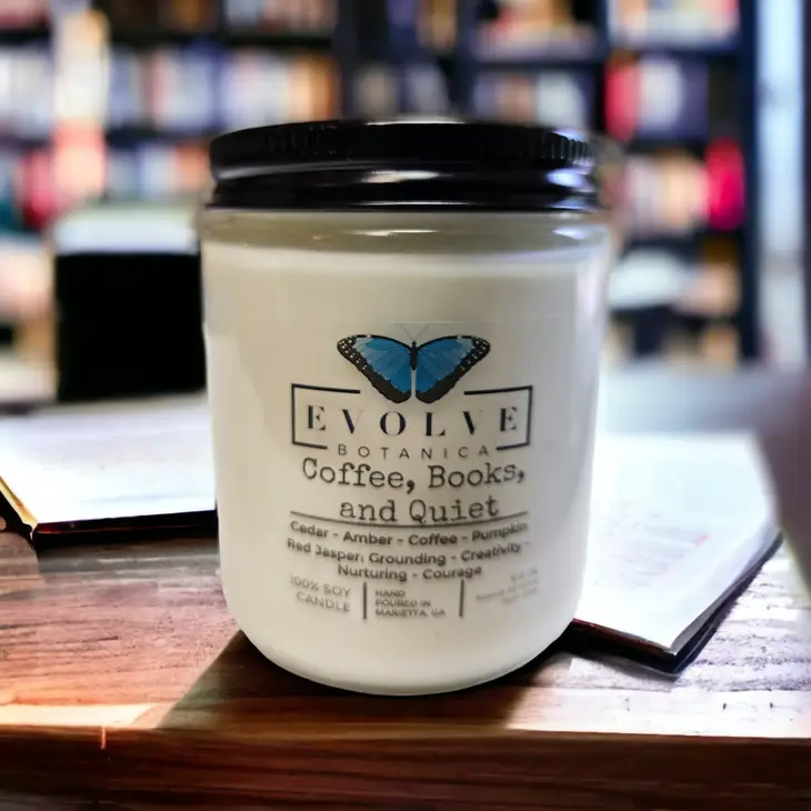 Evolve Botanica Classic 9oz jam jar crystal soy candle with wood wick, featuring coffee, books, and quiet scene in Jasper.