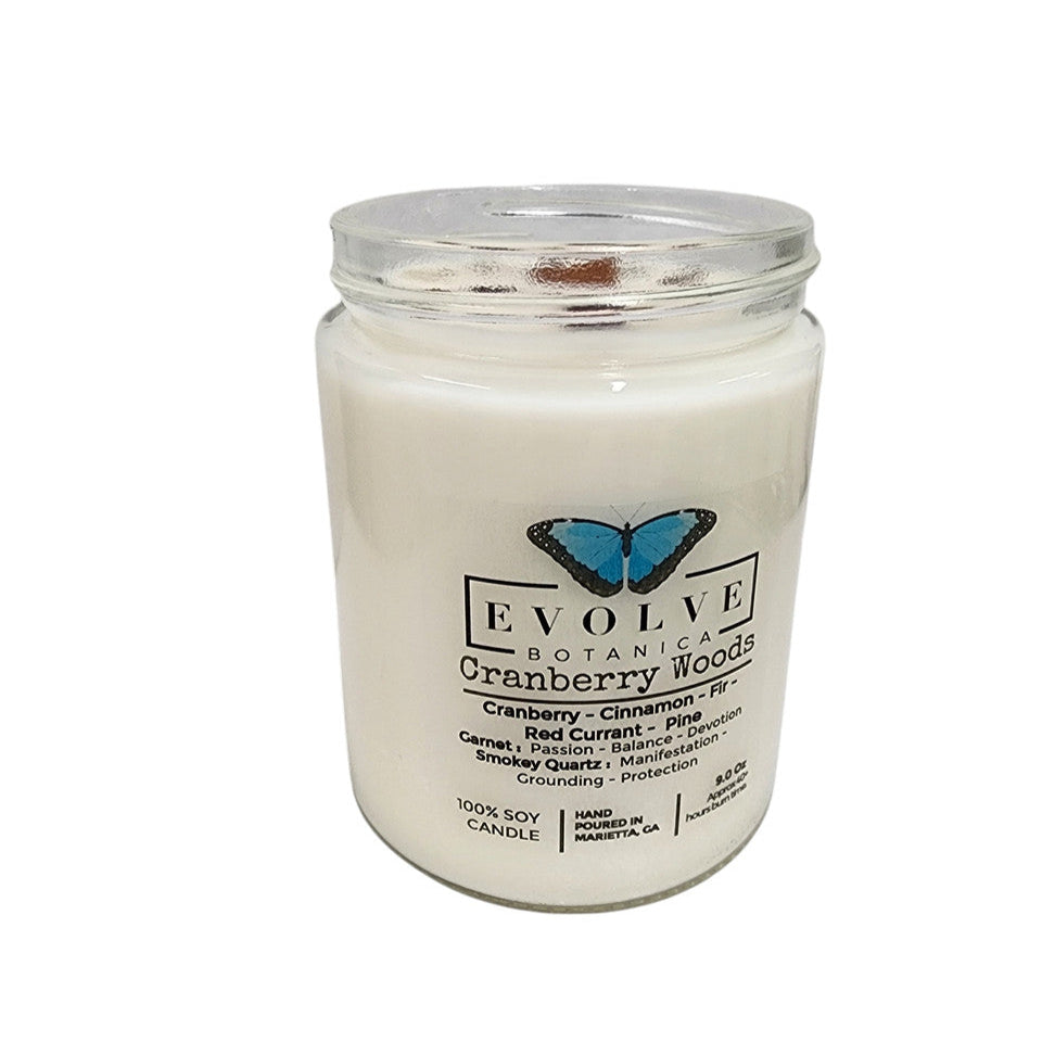 Evolve Botanica Classic 9oz Jam Jar Crystal Soy Candle with cranberry woods scent, garnet, and smokey quartz accents.