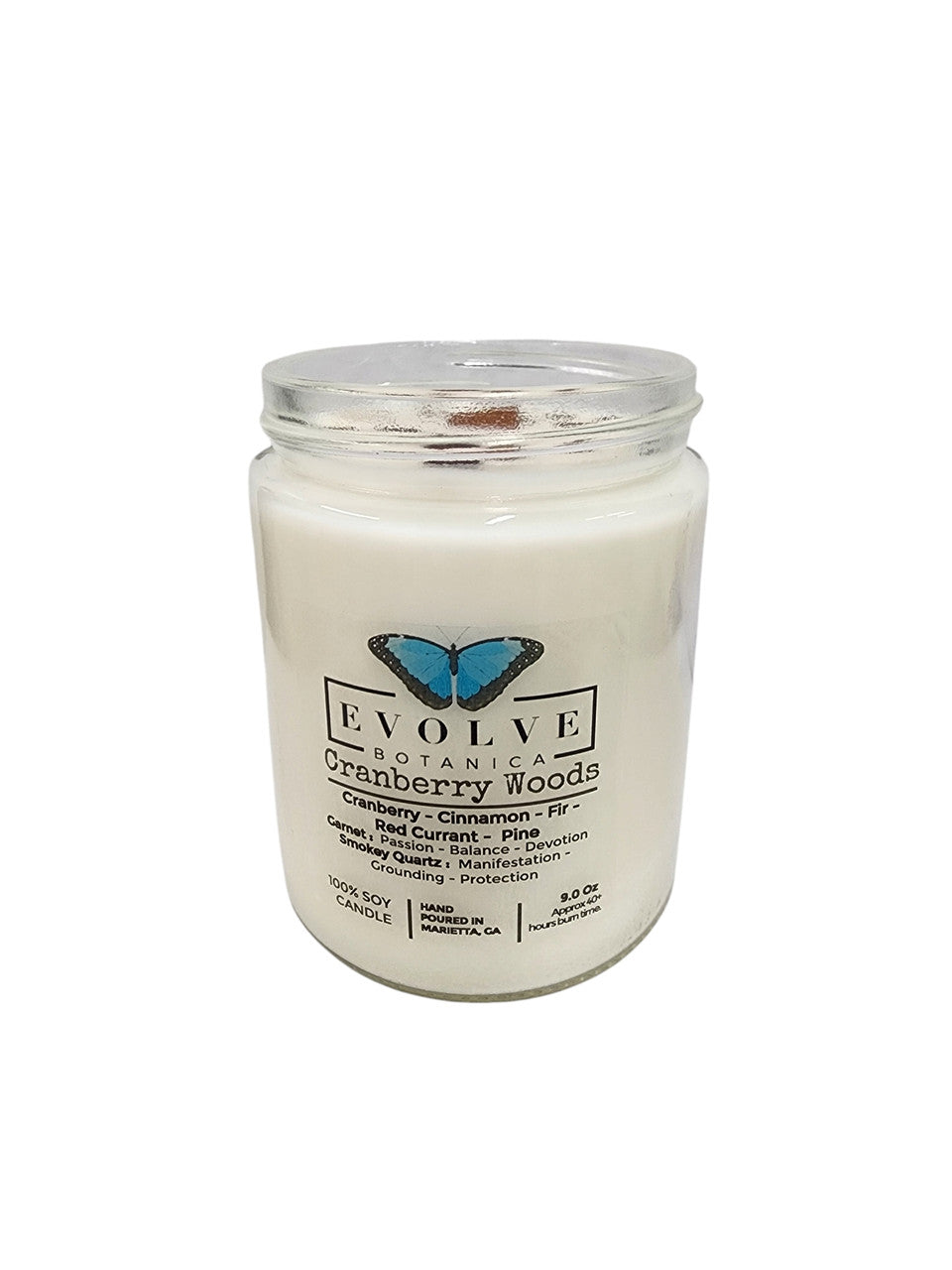 Evolve Botanica 9oz jam jar soy candle with natural wood wick, Cranberry Woods fragrance, garnet and smokey quartz accents.