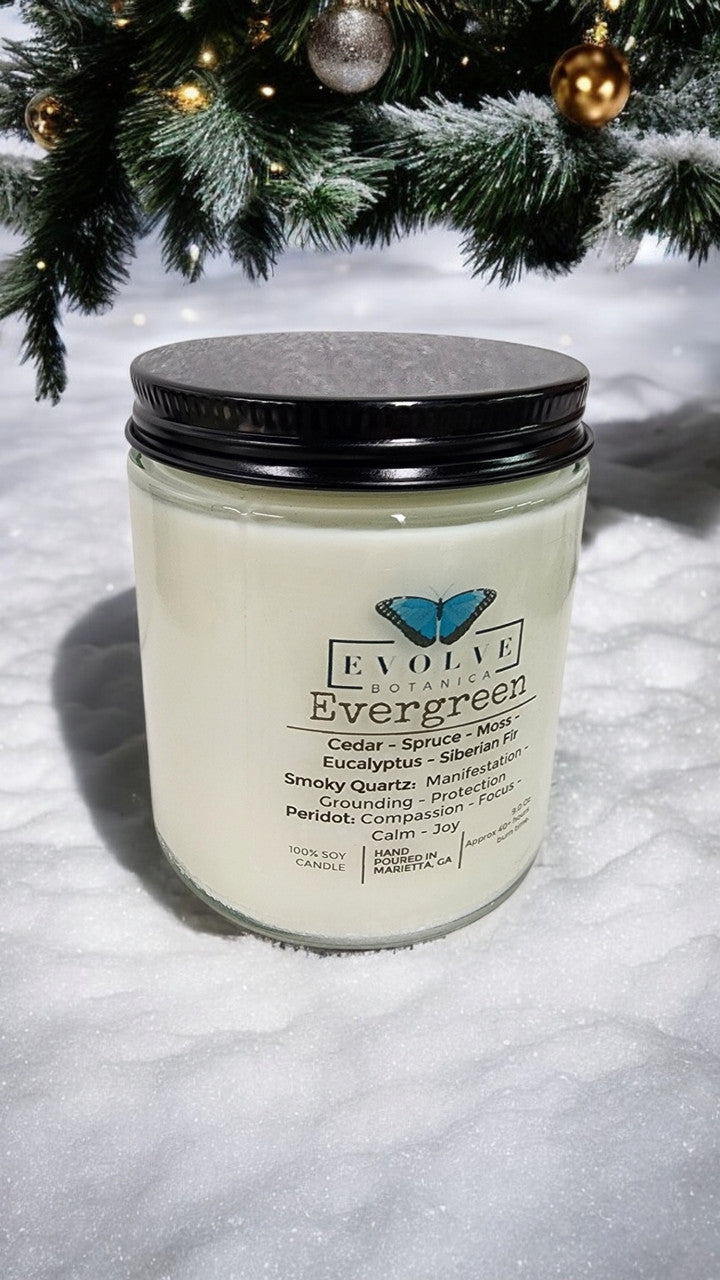 Evolve Botanica Classic 9oz jam jar soy candle with evergreen scent, featuring smoky quartz and peridot crystals, natural wood wick.