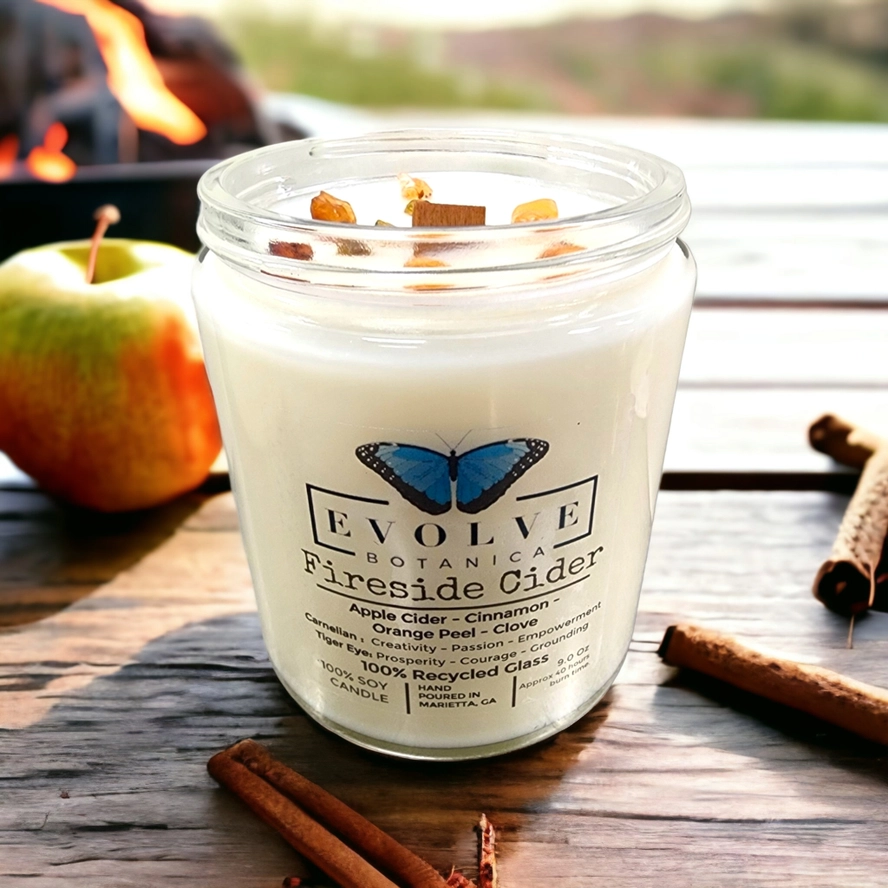 Evolve Botanica 9oz jam jar soy candle with fireside cider scent, Carnelian and Tigers Eye crystals, natural wood wick.