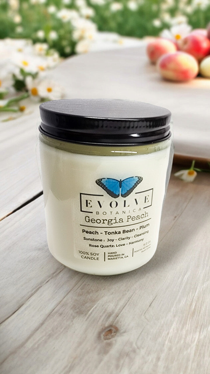 Classic 9oz Jam Jar soy candle by Evolve Botanica featuring Georgia Peach scent, sunstone and rose quartz crystals.