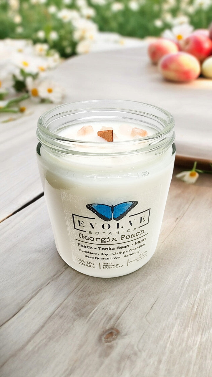 Evolve Botanica 9oz jam jar soy candle in Georgia Peach scent with sunstone and rose quartz crystals, natural wood wick.
