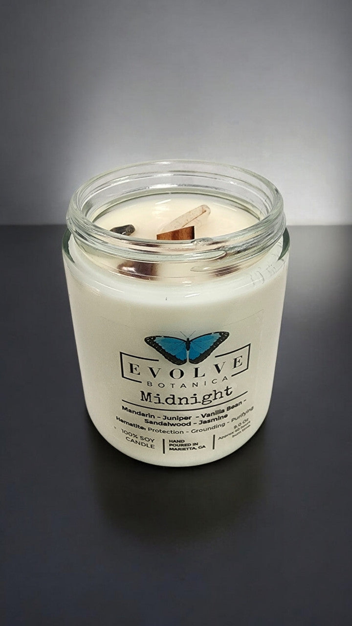 Evolve Botanica Classic 9oz Jam Jar Crystal Soy Candle Midnight Super Seven with natural wood wick, dark glass jar, and aromatic design.