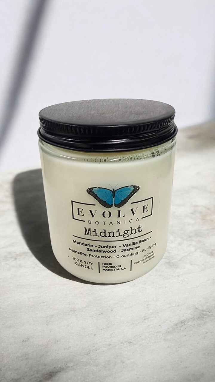 Evolve Botanica 9oz Jam Jar Crystal Soy Candle Midnight Super Seven with natural wood wick, black label, and minimalist design.
