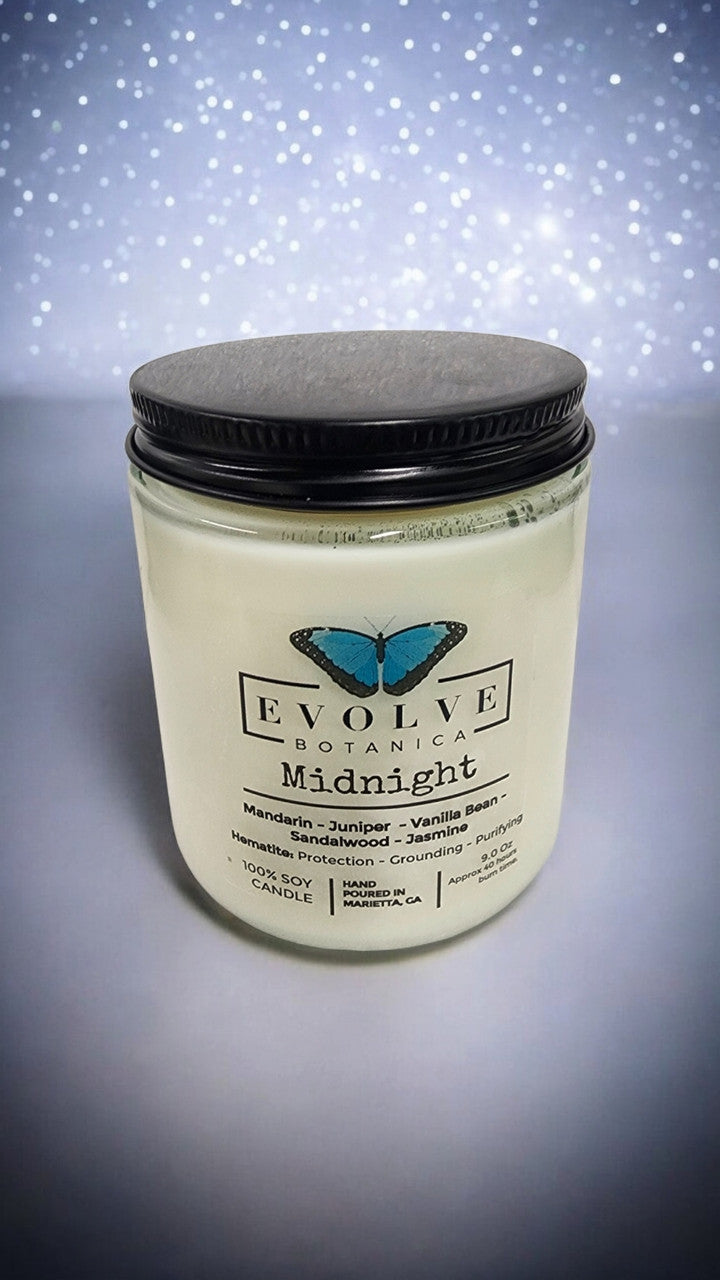 Evolve Botanica classic 9oz jam jar crystal soy candle with natural wood wick, Midnight Super Seven scent, in a clear glass jar.