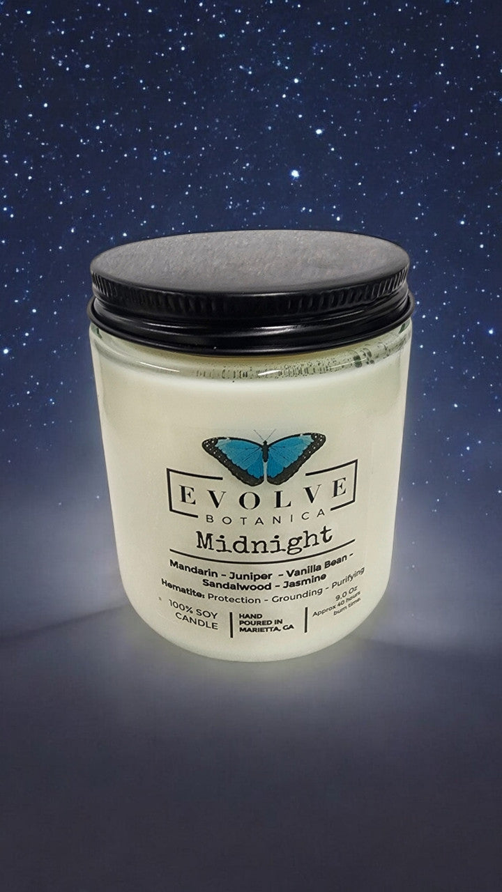 Evolve Botanica Classic 9oz Jam Jar Crystal Soy Candle Midnight Super Seven with natural wood wick, dark-colored jar, cozy ambiance