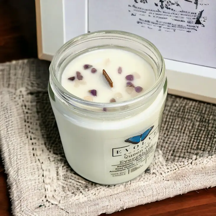 Evolve Botanica 9oz jam jar soy candle with rose quartz and amethyst crystals, featuring a natural wood wick and floral design.