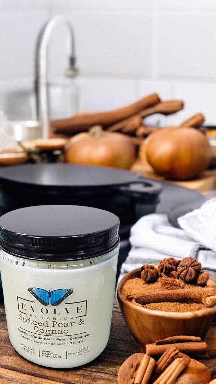 Evolve Botanica 9oz jam jar crystal soy candle with natural wood wick, Spiced Pear & Cognac scent in Garnet color.