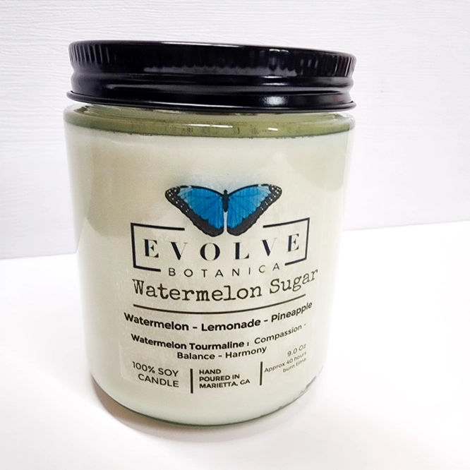 Evolve Botanica 9oz jam jar soy candle with Watermelon Sugar scent, featuring a crystal Watermelon Tourmaline design and natural wood wick