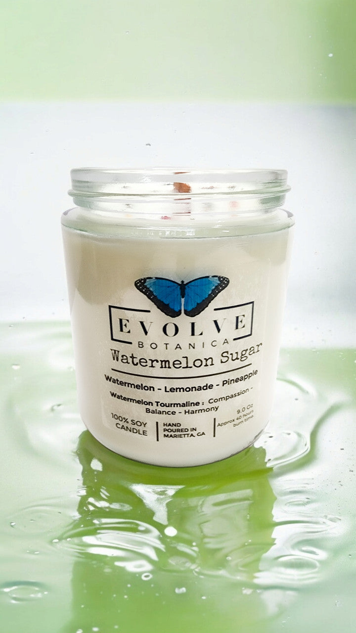 Evolve Botanica 9oz jam jar crystal soy candle with watermelon sugar scent and natural wood wick, featuring a Watermelon Tourmaline crystal.