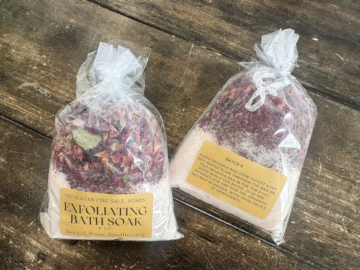 Herbalroseapothecary exfoliating herbal bath soak with dried herbs and natural ingredients in a clear jar for relaxing bath rituals.