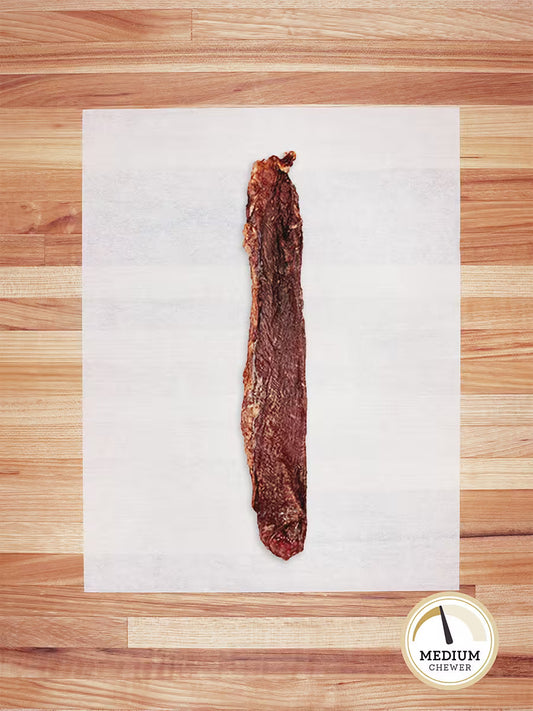 A single Farm Hounds Beef Weasand—esophagus from pasture-raised cattle—rests on white parchment atop wood. In the bottom right, a circle reads MEDIUM CHEWER with a dog chew icon.