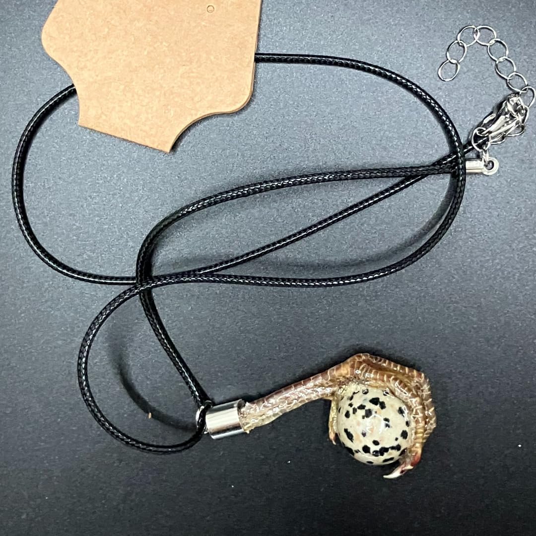 Quail foot necklace featuring a stone that resembles a quail egg, crafted by Quailz.com by Undique LLC, with detailed foot and stone design.