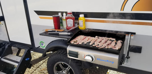 Flame King 17-inch LP griddle with small regulator for RV pullout, ideal for outdoor cooking and camping.