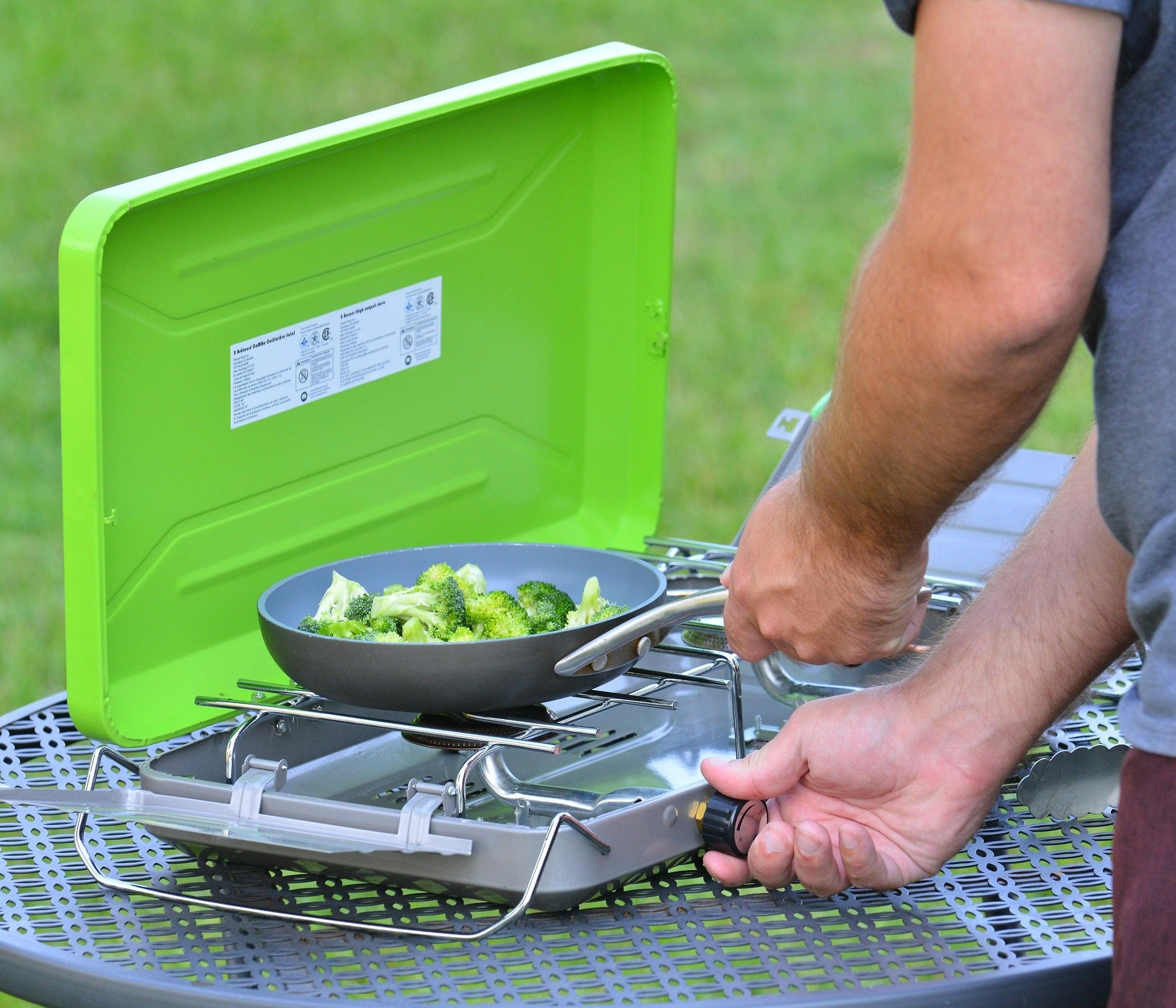 Flame King 2 Burner Portable Propane Camping Stove and Grill with metal handles and control knobs for outdoor cooking.