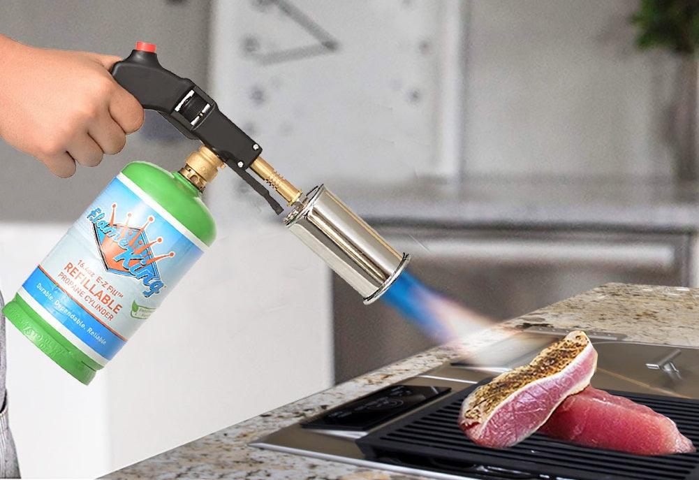 Flame King high-intensity propane searing torch with electric start and comfort handle, used for cooking and searing food.