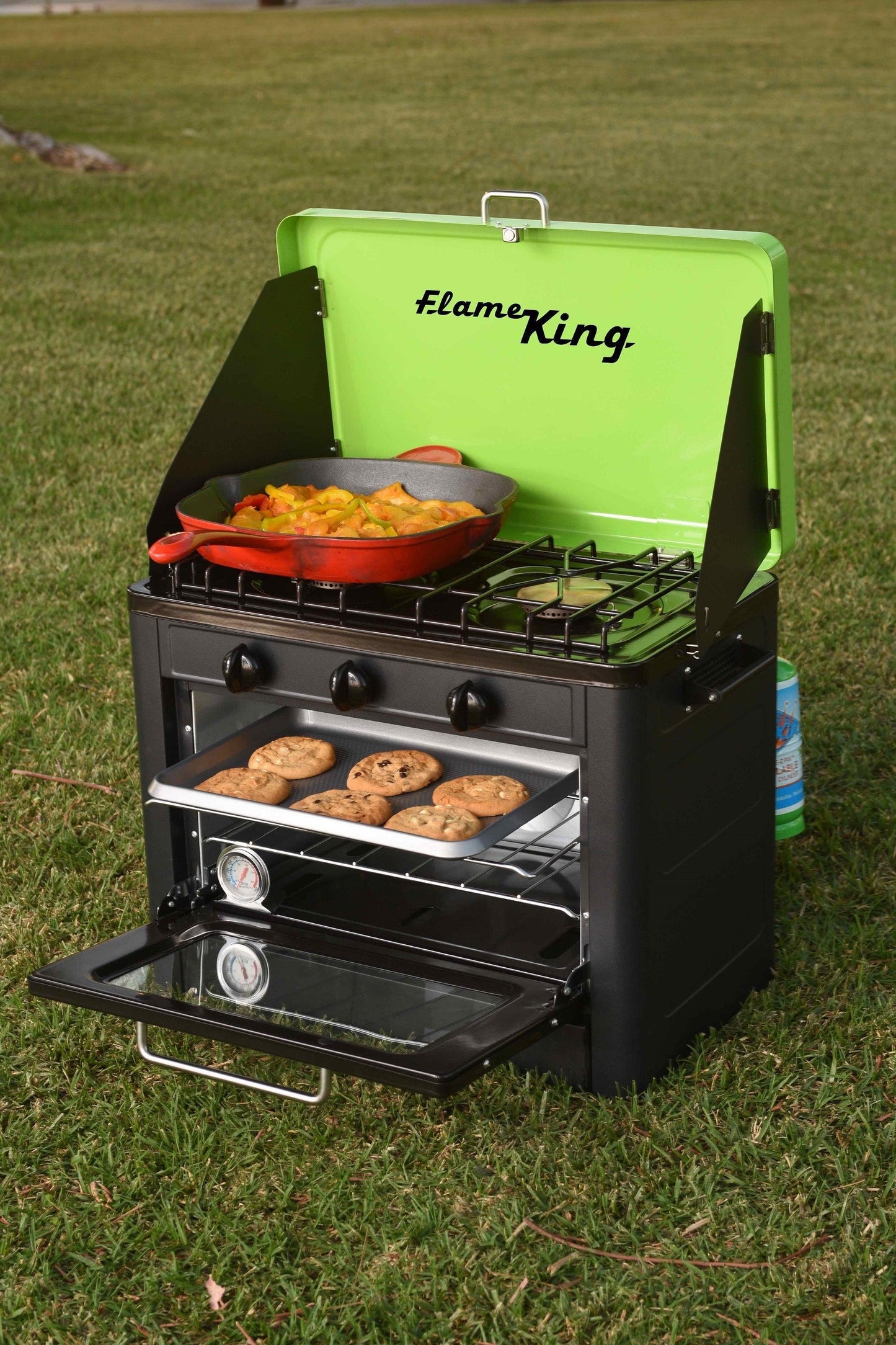 Portable Flame King camping oven and stove combo with compact design, ideal for outdoor cooking and camping adventures.