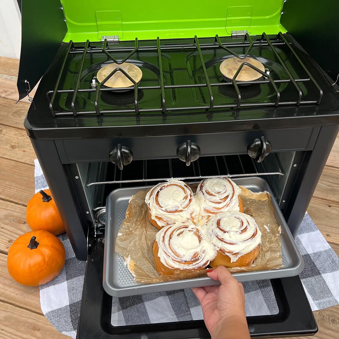 Portable Flame King camping oven and stove combo with compact design, ideal for outdoor cooking and camping adventures.