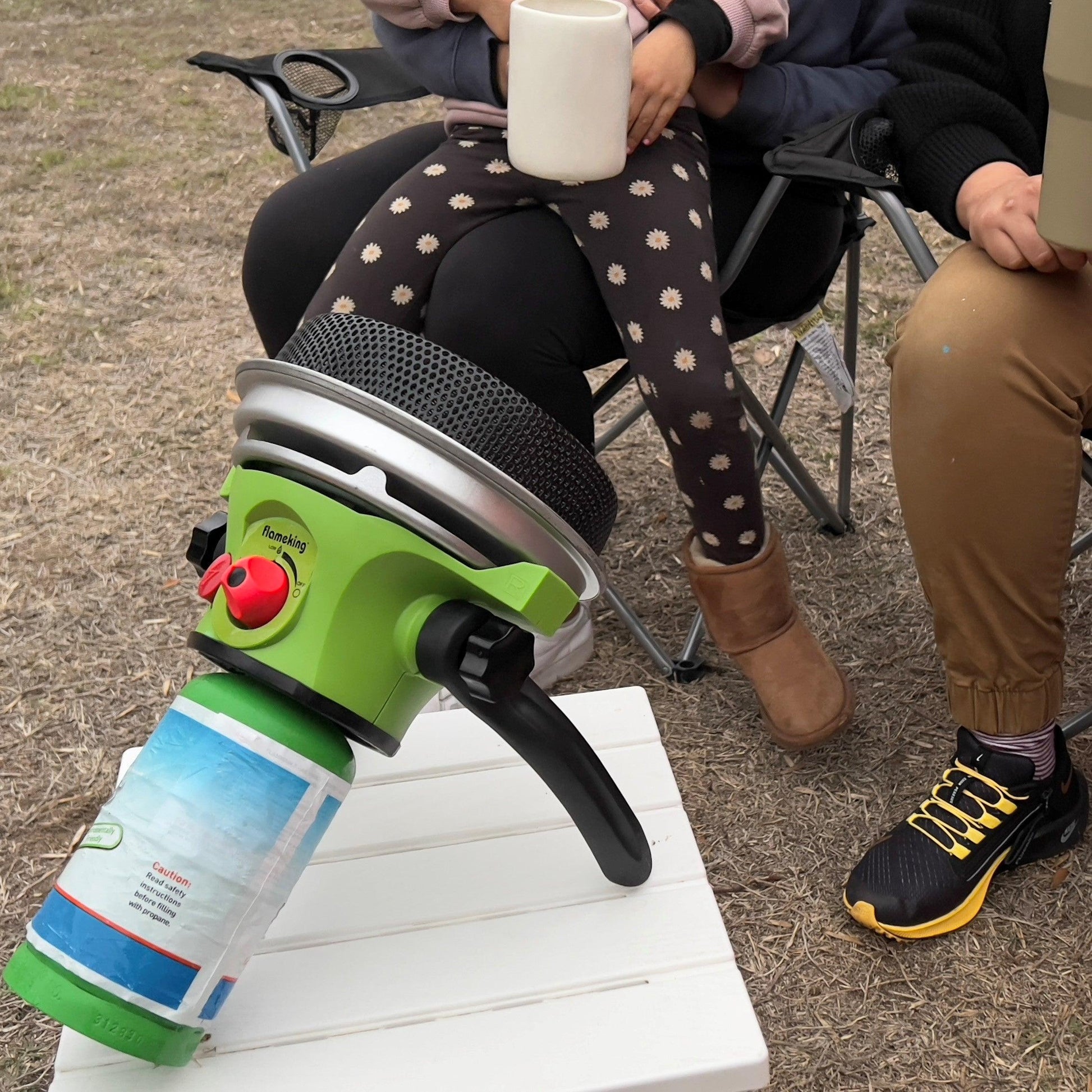Portable Flame King propane outdoor camping heater with piezo electric start, compact and suitable for outdoor warmth.