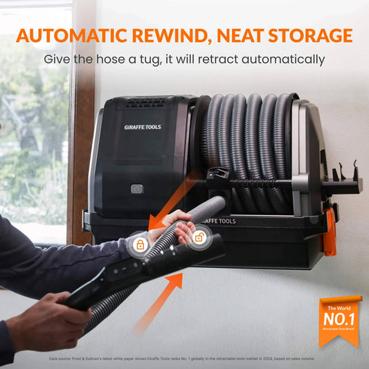 Giraffe Tools US Grandstorm Retractable Garage Vacuum cleaner with hose and attachments, mounted in a garage setting