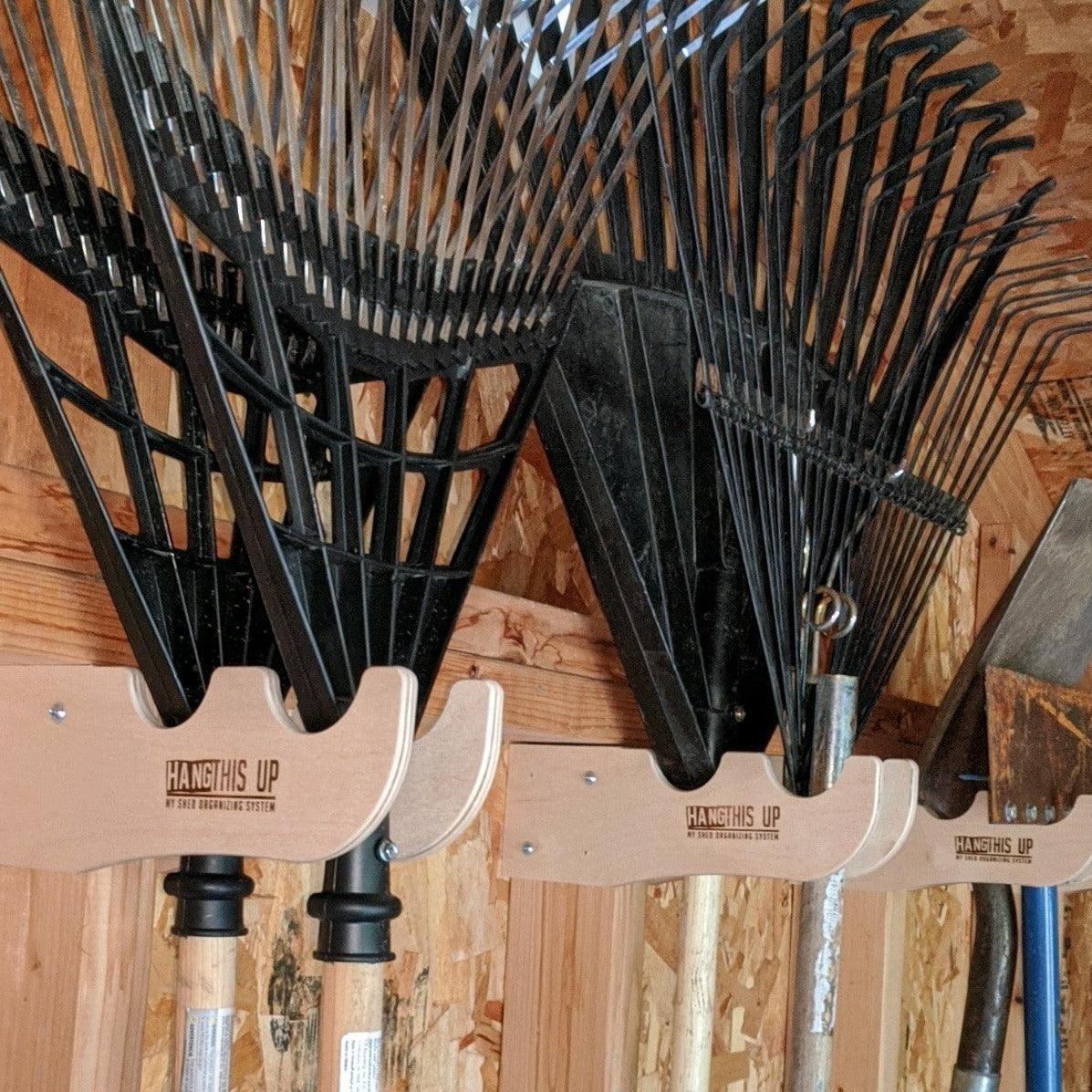 Outdoor garden tool organizer rack by HangThis Up, shed storage for yard tools, keeping garden tools neatly arranged and accessible.