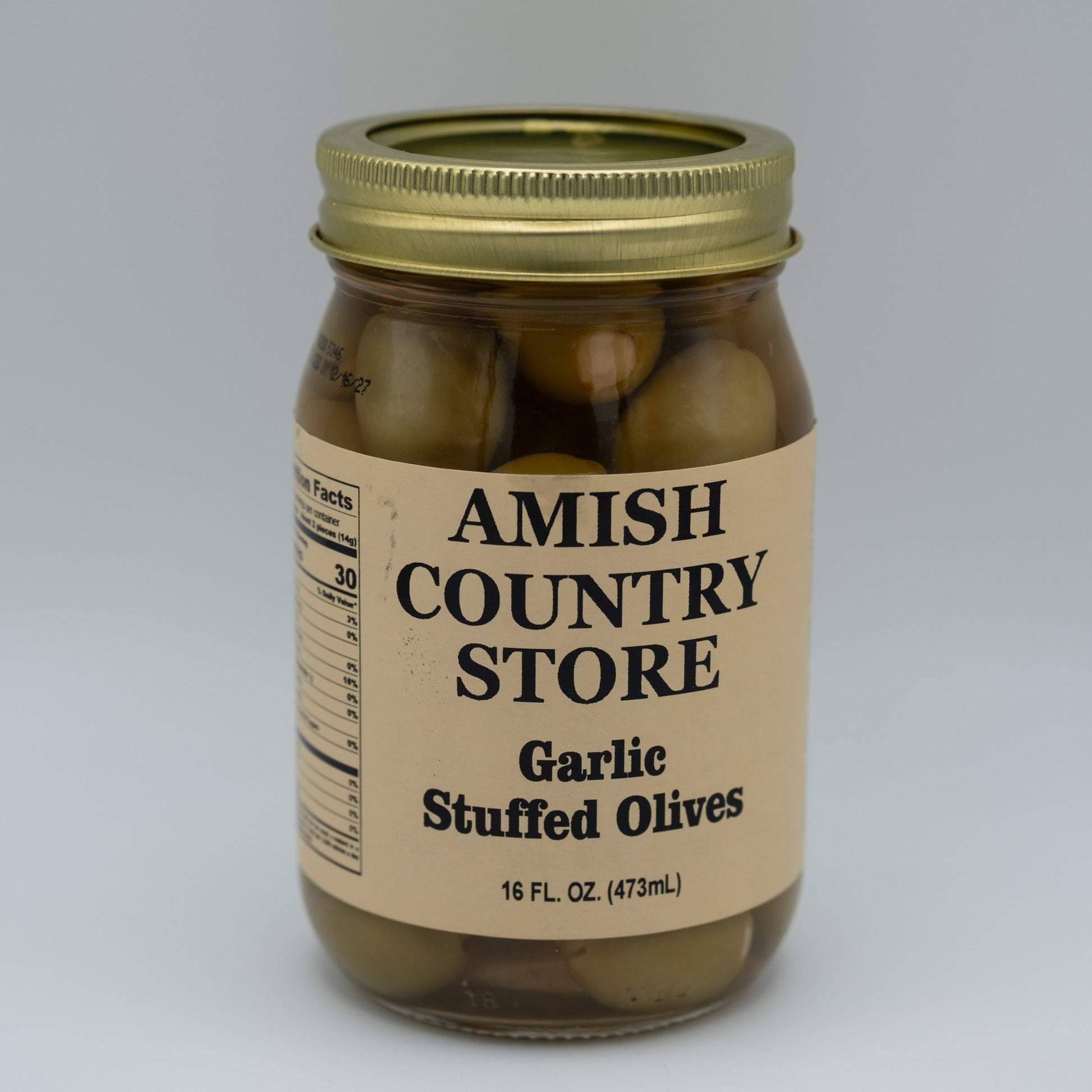 Canned garlic stuffed olives in a 16oz jar from Amish Country Store, showing green olives filled with garlic cloves.